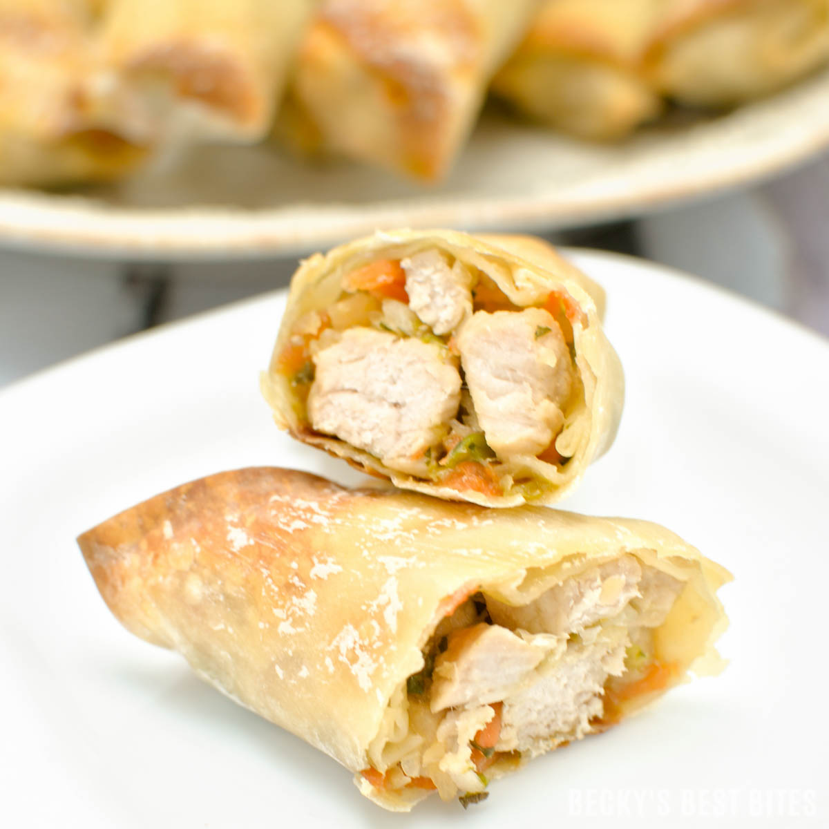 Pork and Vegetable Baked Egg Rolls are a healthy, crispy and delicious appetizer recipe served with a creamy spicy dipping sauce. No need to order take-out when you have this recipe in your wheelhouse! | beckysbestbites.com